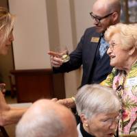 Two event guests greeting each other and shaking hands